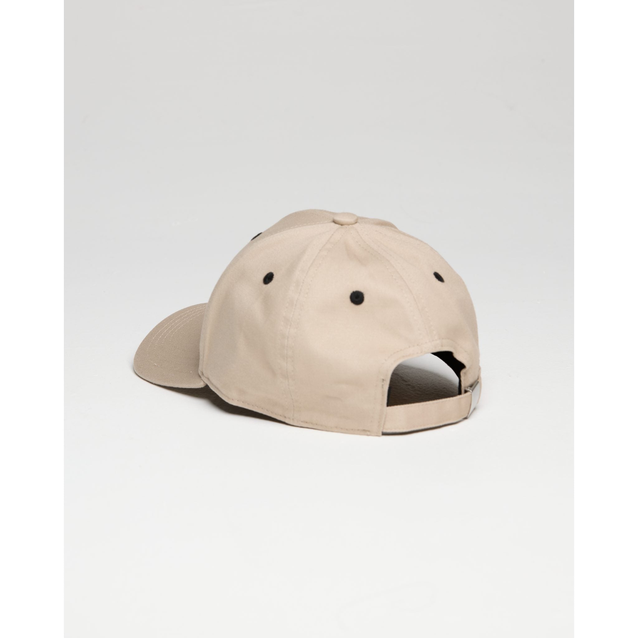 Beige cap with a unique design on a light gray background