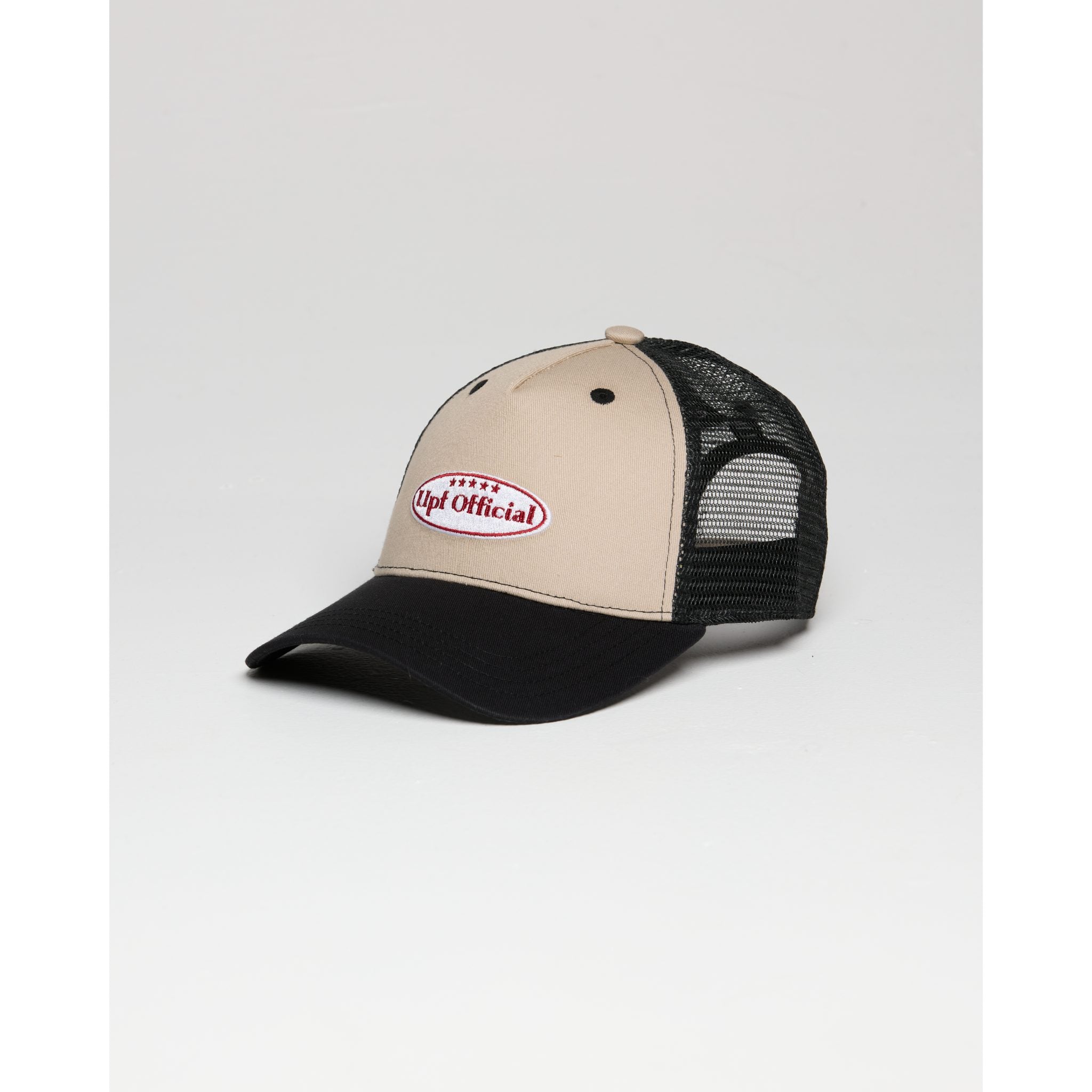 Beige and black cap with a logo on a light gray background