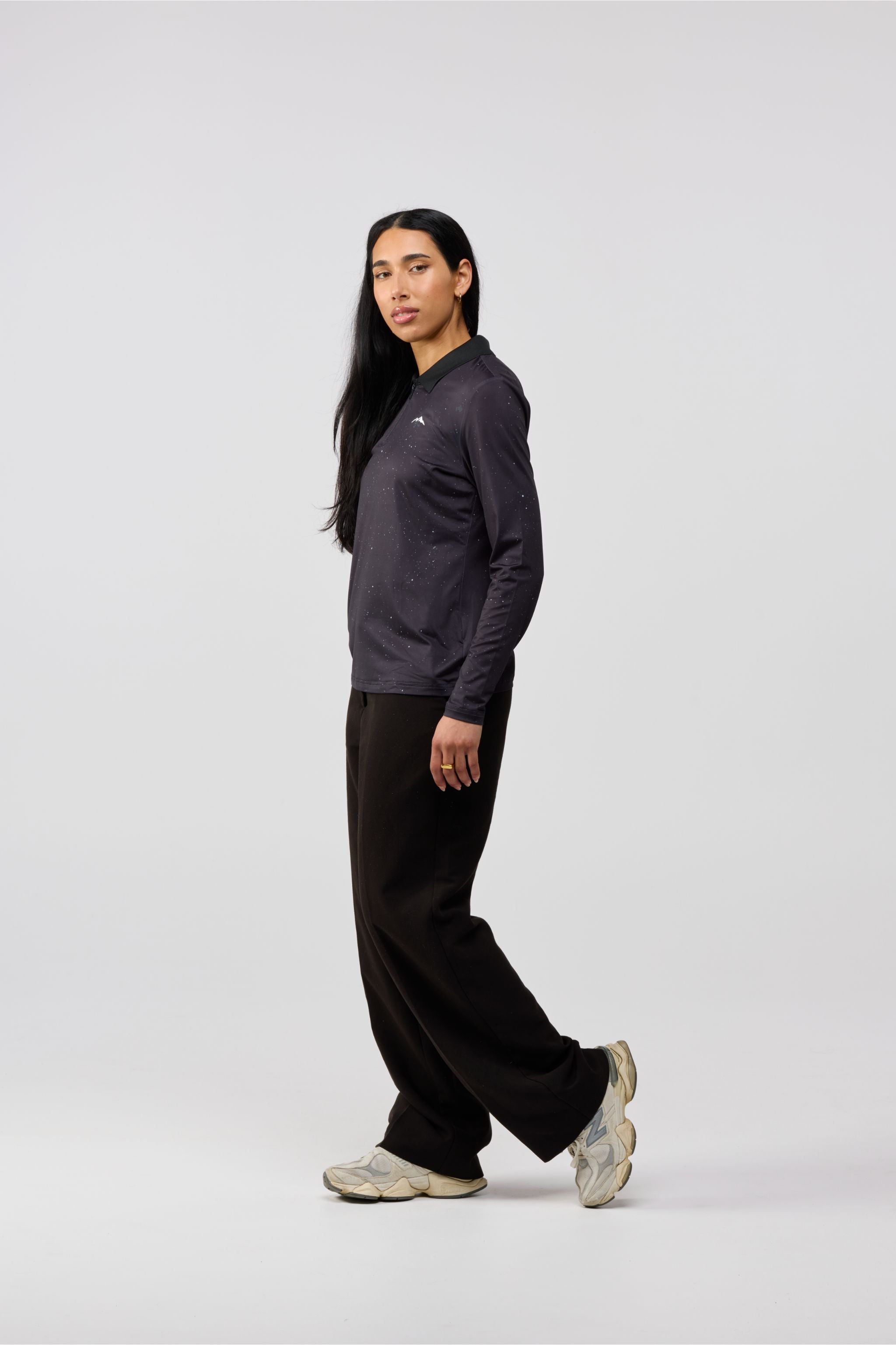 Side profile of Solar Line black graphic shirt showing modern fit and long sleeves.